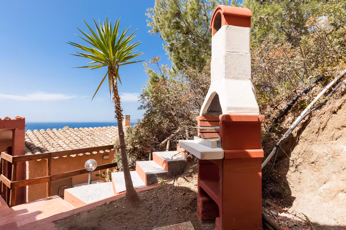 The masonry barbecue in the hillside garden