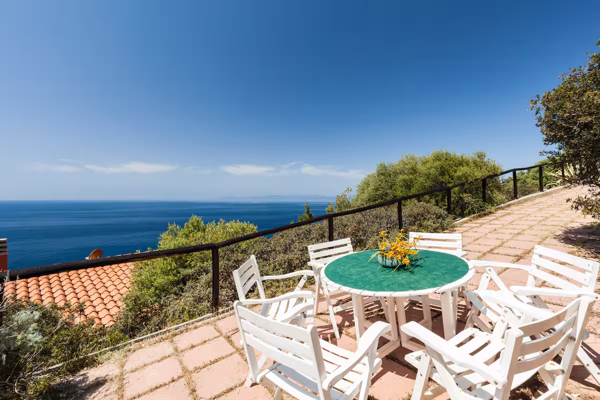 The outdoor dining table on the terrace, set against the open sea