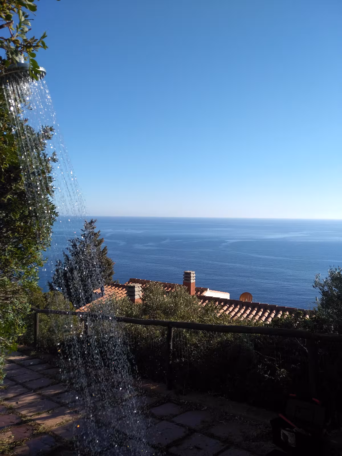 The outdoor shower with the sea on the horizon