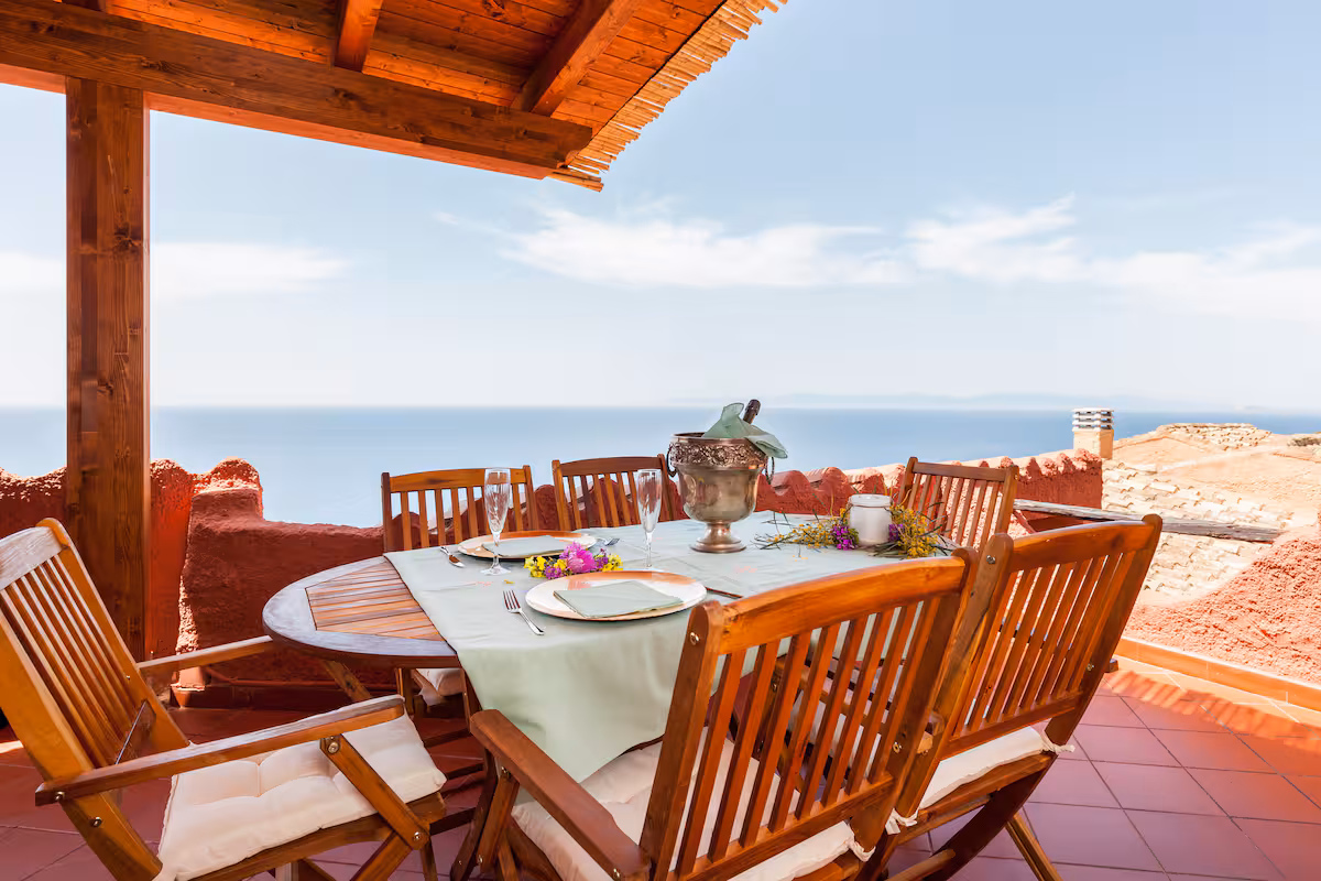 The long table laid for guests, a few steps from the sea