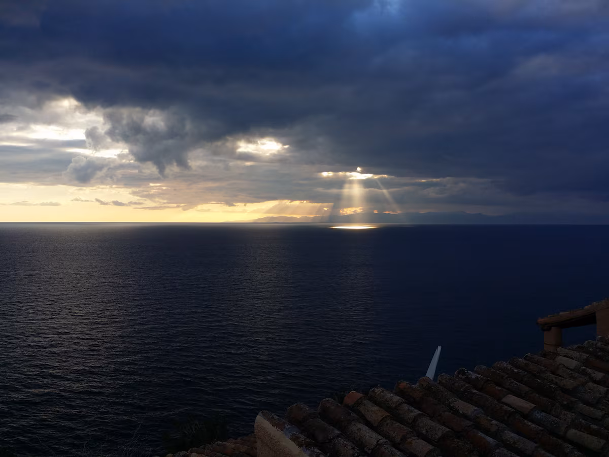 Sunbeams breaking over the sea after an afternoon storm